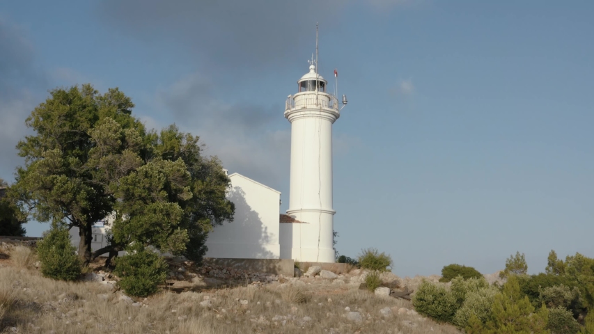 Gelidonya lighthouse on a background of mountains. Beautiful ladscape with green trees