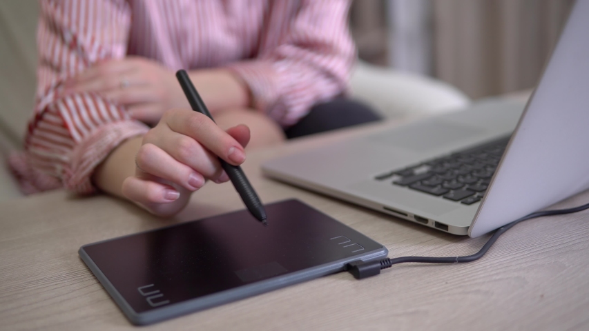 Graphic designer using laptop, tablet and pencil, hand close up, painting illustartion, freelancer,