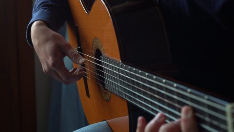 Close Up Of Hands Playing The Guitar