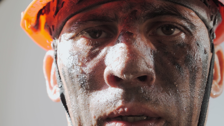 Portrait Dirty Mine Worker. Sweaty Exhausted Man in a Hard Hat. Filthy Job and Physical labor. Coal mining. People Working Equipment. Close up. | Shutterstock HD Video #1054760621