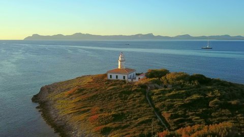 AERIAL WS Alcanada Lighthouse in sunlight, Bay of Alcudia, Alcudia / Majorca, Spain