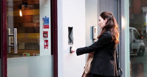 MS PAN Woman using electronic ID card to enter to office building / London, UK, Business/Finance, People