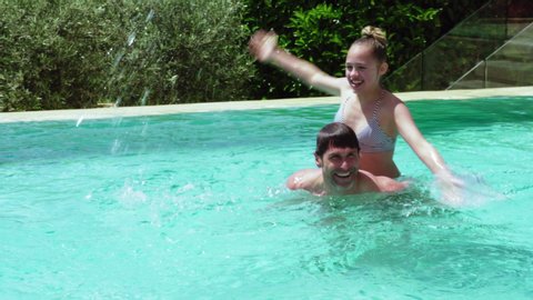 WS Father and daughter (12-13) playing in pool, Holidays, People