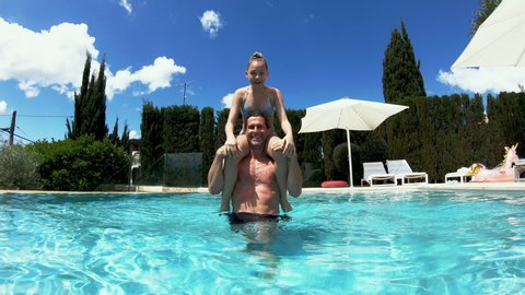 WS Father carrying daughter (12-13) on shoulders in pool, Holidays, People
