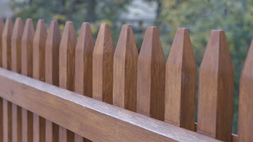 Wooden fence. Beautiful new wooden picket fence. Royalty-Free Stock Footage #1054767206