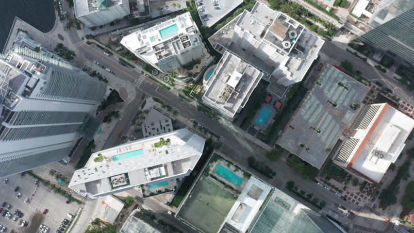 Bird-eye view on lots of pools on roofs of the residential homes. 4K aerial top-down view on wealthy Downtown Miami district. Expensive real estate in skyscrapers at the tropical city, Florida, USA