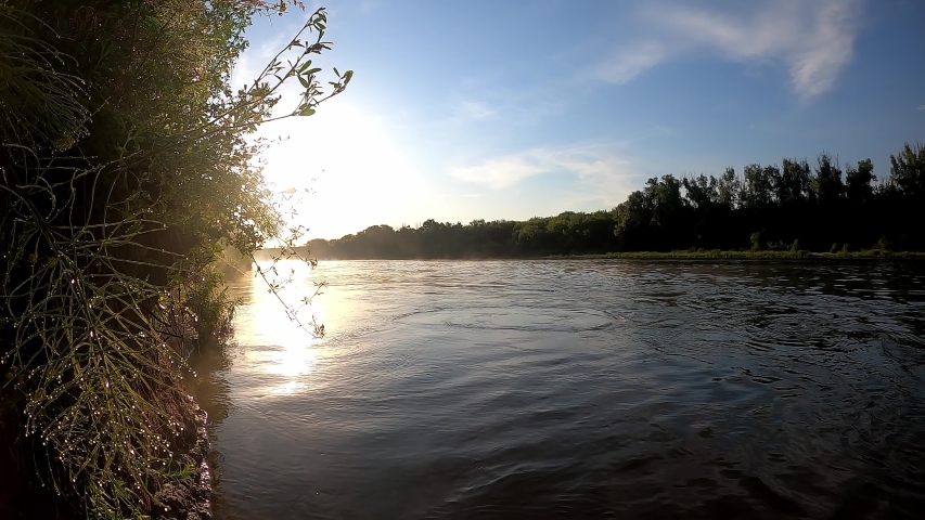 Sunrise on a river with a strong current. Timelapse.