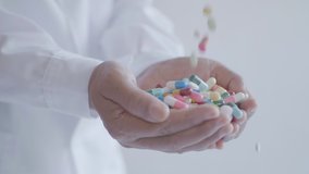 Pills being poured into hand in slow motion, Multi shot
 - Powered by Shutterstock - Get 15% off with code: PIKWIZARD15