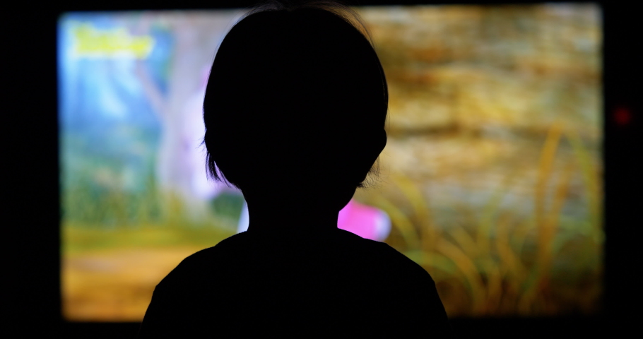 Little child silhouette back looking at TV screen watch cartoons, abandoned to media, modern childhood | Shutterstock HD Video #1054793546