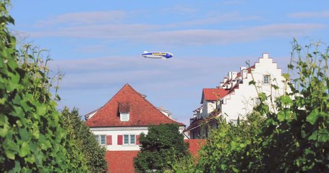 Hödinger, Baden-Württemberg/Germany - 06/21/2020: Zeppelin with Good Year banner fly over the buildings. 