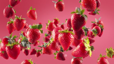 Flying of Strawberry in Light Fuchsia Background