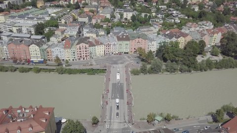 Innsbruck /Austria - JULY 30Innsbruck /Austria - JULY 30 2018: Aerial view of bridge road over Inns river in Innsbruck city, Austria. Colorful houses stands on riverside. South Tyrol, Alpine mountain