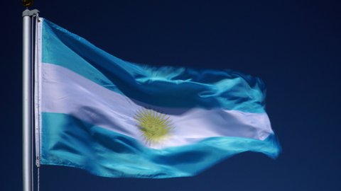4K: Argentina Flag flying in the wind outdoors with Blue sky behind - Argentinian flag on flagpole. Stock 4K Video Clip Footage