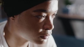 Close up face sad thoughtful young african american single woman looking away thinking of problems sit alone at home troubled negative slow motion - Powered by Shutterstock - Get 15% off with code: PIKWIZARD15