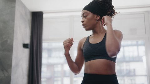 Athletic fit african american woman doing fitness exercises training full body core muscles working out at home. Self isolation. Self development. Sports and workout.