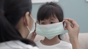 Asian family with mother wear mask daughter her for protection pandemic corona or COVID-19 close-up - Powered by Shutterstock - Get 15% off with code: PIKWIZARD15