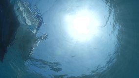 diver jumping in the water from boat underwater diving scenery slow motion ocean scenery sun beams and rays