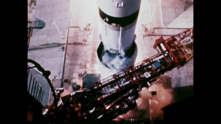 1969 - NASA's Apollo 11 is launched from Cape Kennedy, and men in Mission Control watch its ascent through binoculars.