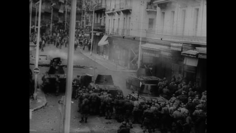 1960 - Civilians and military forces clash in France over protests about Algeria, and President de Gaulle is swarmed by a large crowd.
