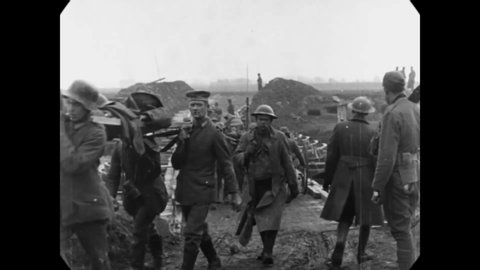 1918 - Soldiers carry casualties over a pontoon bridge into Ypres, Belgium.