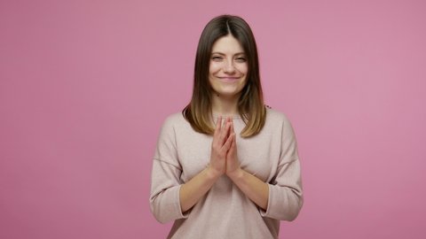Sneaky scheming brunette woman with tricky face gesticulating and scheming evil plan, thinking over devious villain idea, cunning cheats and pranks. indoor studio shot isolated on pink background