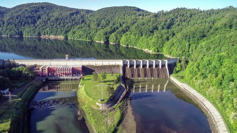 Roznow dam, lake and hydroelectric power plant on the Dunajec River in Poland. Aerial approaching video. Early morning in spring