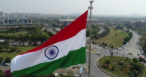 Drone shot of the Indian Tricolor Flag Fluttering in a commercial complex in Gurugram (old name: Gurgaon), India- Mid Shot