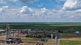 Aerial View of Oil and Gas Refinery with White Clouds Over Blue Sky. Petrochemical Plant at Day Time. Oil and Gas Refinery Aerial Drone Video. 