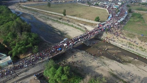 View from above of Dajabon bridge and mass of people crossing border. Dominican Republic