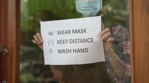 wear masks, keep your distance and wash hand sign on shop front door when new normal during coronavirus outbreak in the city