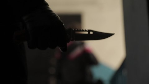 Murderer with flick-knife in the hands kills his victim. 