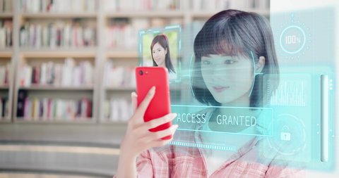 young woman use smart phone unlocking with biometric facial identification indoor