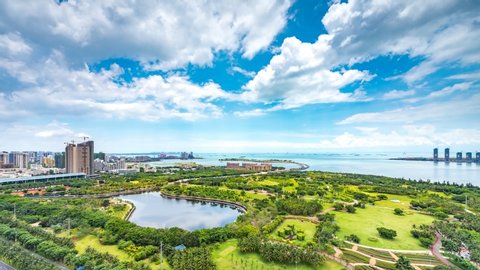 Timelapse Video of Haikou City Evergreen Park by the Bay with Blue Sky and White Clouds, Hainan Province, China, Asia.
