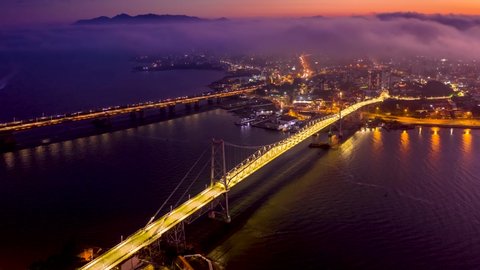 Hercilio Luz bridge at sunset, view from the top, Forianopolis, Santa Catarina, Brazil, cloudy day, hyperlapse drone movement up and to the right