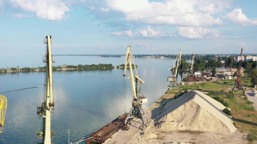 port tower crane. Cargo river port. Tower crane on the river. Town. Sand. Summer. Cherkasy city.