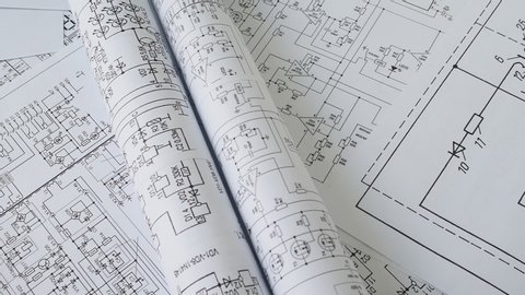 paper electrical engineering drawings, pencils and digital multimeter