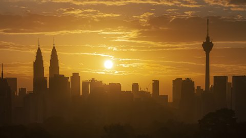 Time lapse: Dramatic Silhouette of Kuala Lumpur city view during dawn overlooking the city skyline with lushes green in the foreground. Federal Territory, Malaysia. Prores UHD