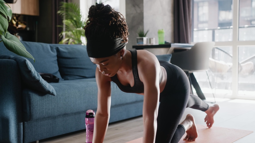 African american woman in sportswear doing workout burning fat calories training strength practicing effort domestic fitness females aerobics sport fit at home slow motion | Shutterstock HD Video #1054862261