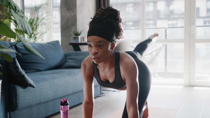 African american woman in sportswear doing workout burning fat calories training strength practicing effort domestic fitness females aerobics sport fit at home slow motion | Shutterstock HD Video #1054862261