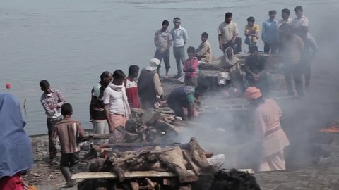 View of the ghat with burning bodies on the Ganges. This video shows the ancient ritual of burning the bodies of people after their death. Varanasi, India. February 2014