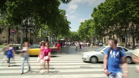 Time lapse video of people and traffic on the busy pedestrian crossing, La Rambla, Barcelona, Spain