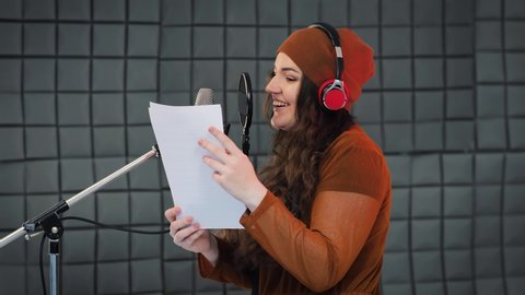 Voice acting of characters, recording in studio, reading text from script. Voice artist acting a role of some cartoon character