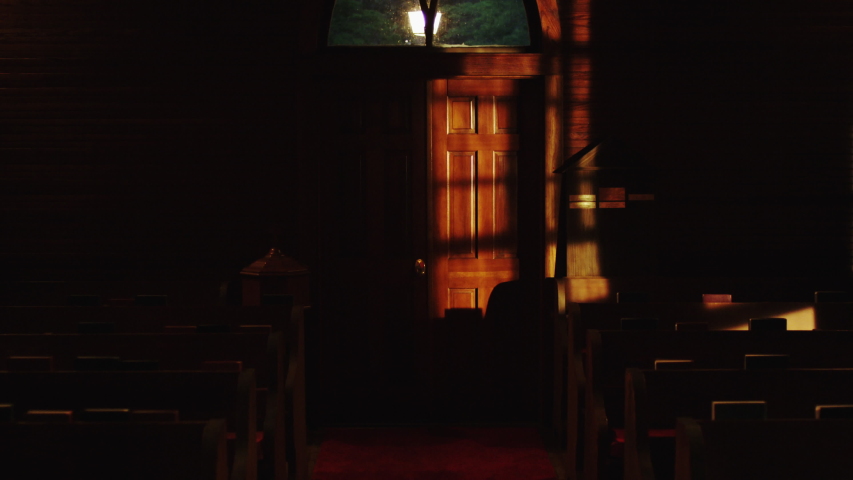 Lights go out in church pew. Church pew lit by window light goes dark when shutters are closed. | Shutterstock HD Video #1054874756