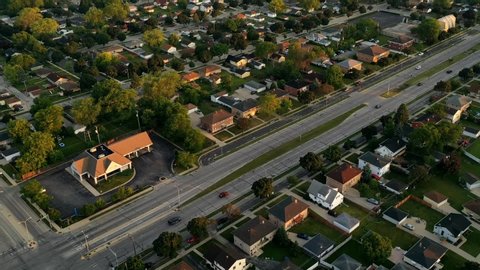 Aerial view of american suburb at summertime.  Establishing shot of american neighborhood. Real estate, top down view of residential houses. Drone shot, from above