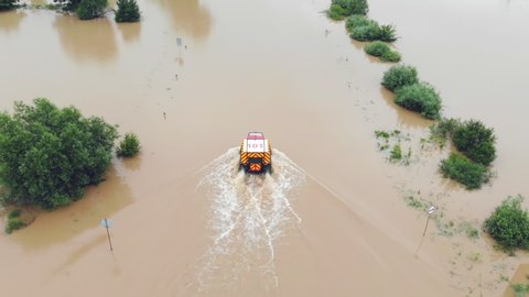 Ukraine. Galych 24 June 2020. Aerial View of The ambulance goes on the flooded road of the city which was flooded by floods of the river. Rescuers go to rescue people in flooded houses
