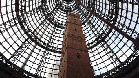 Melbourne, Australia - May 13, 2019: Slow motion pan of the historic Coop’s Shot Tower (50m) at the atrium of Melbourne Central Shopping Centre. In the Central Business District (CBD) area.