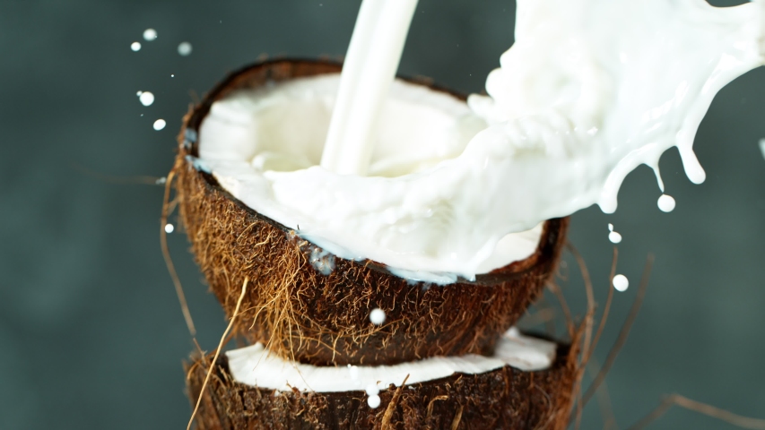 Super Slow Motion Shot of Milk Splashing on Coconut at 4K. | Shutterstock HD Video #1054895936