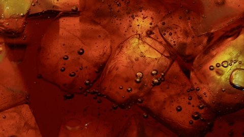 Ice Cubes with Cola, Macro Shot. Super Slow Motion Filmed on High Speed Camera.