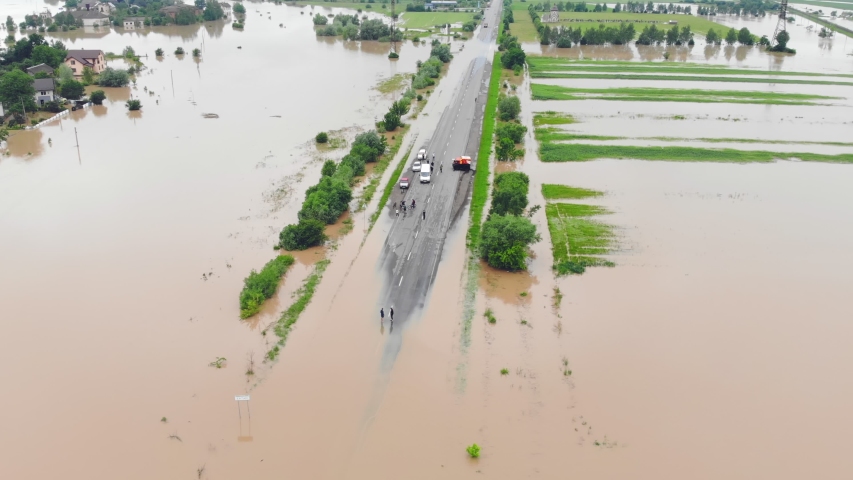 Flooded highway. Flooded road during floods. Cars that can not pass on the road flooded river.