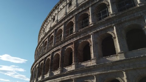 Facade of the Colosseum illuminated by the morning sun. Slide on the arches of the Colosseum symbol of Rome.